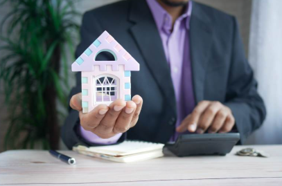 Realtor holding a toy house